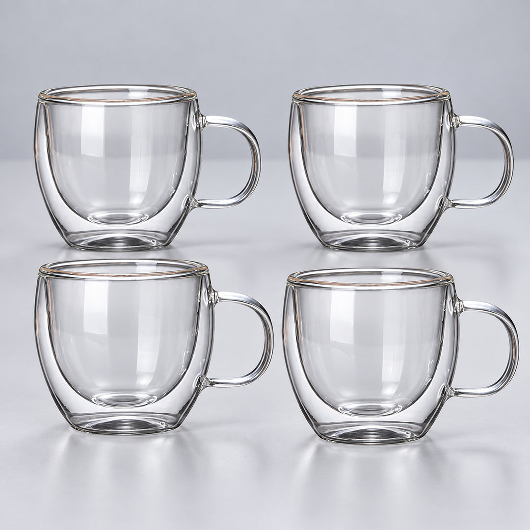 Four empty small 150 ml clear double-wall glass mugs with handles.