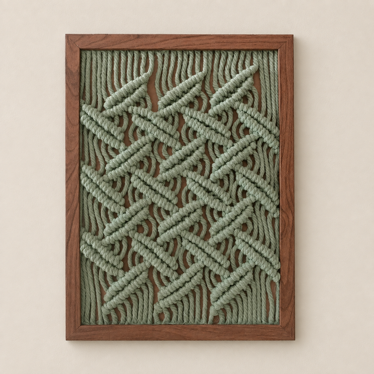 Coral frame propped on a desk under a lamp, macrame panel in 13 knot styles