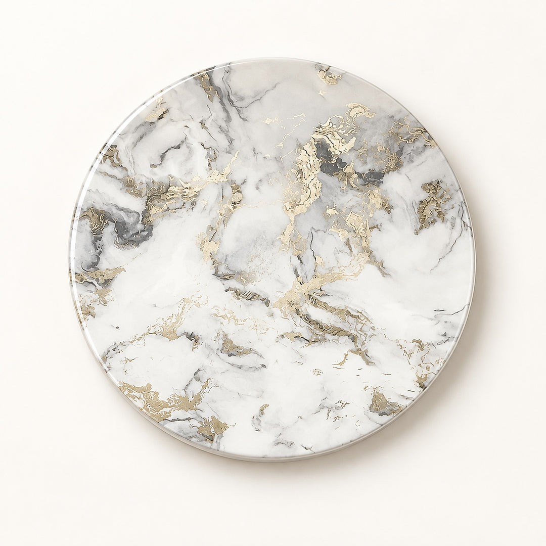 A round coaster or tray with a white marble pattern and metallic gold accents, photographed from directly above on a clean white background.