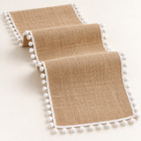 One tan runner with white pom pom trim, selected length.