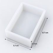A white rectangular tray or mold shown on a light gray background with dimension arrows and labels indicating 8.7 cm, 5.
