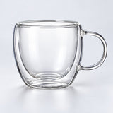 One empty small 150 ml clear double-wall glass mug with handle.