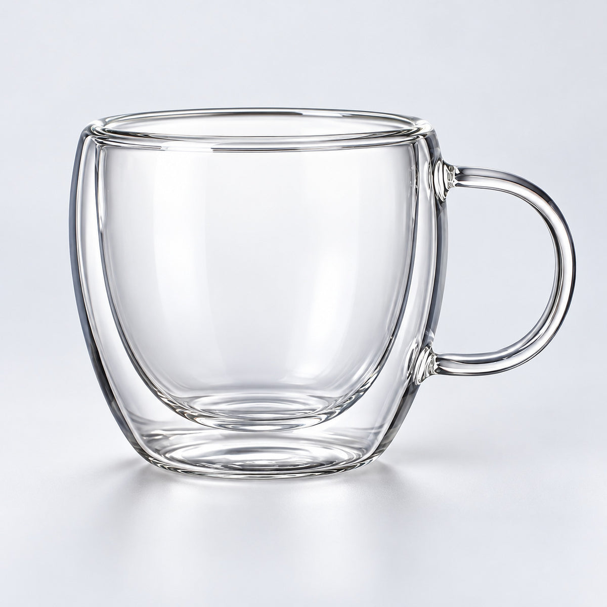 One empty small 150 ml clear double-wall glass mug with handle.