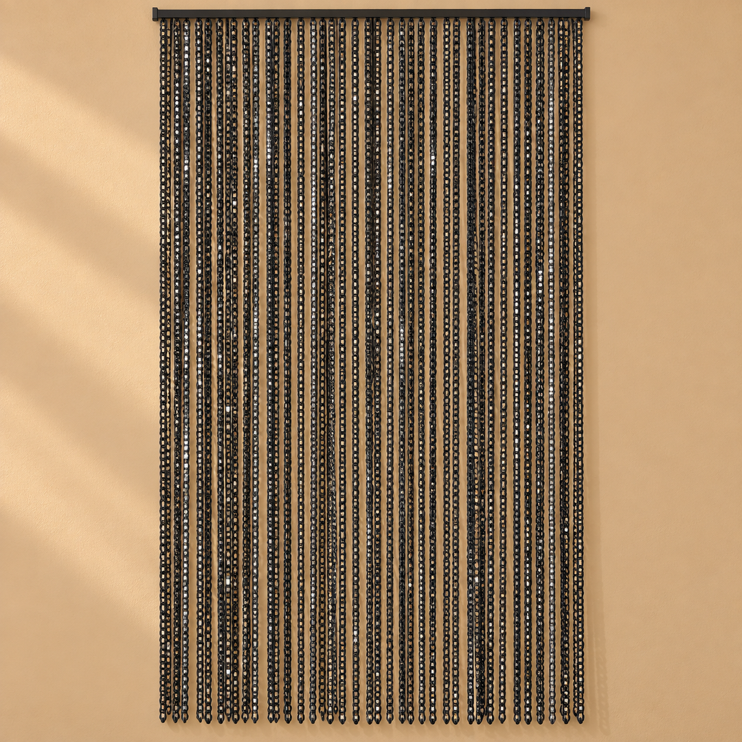 A black beaded curtain hanging from a top rod against a warm beige wall, with vertical strands of small reflective beads creating a shimmering effect.