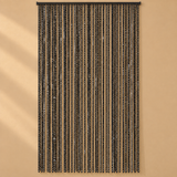 A black beaded curtain hanging from a top rod against a warm beige wall, with vertical strands of small reflective beads creating a shimmering effect.