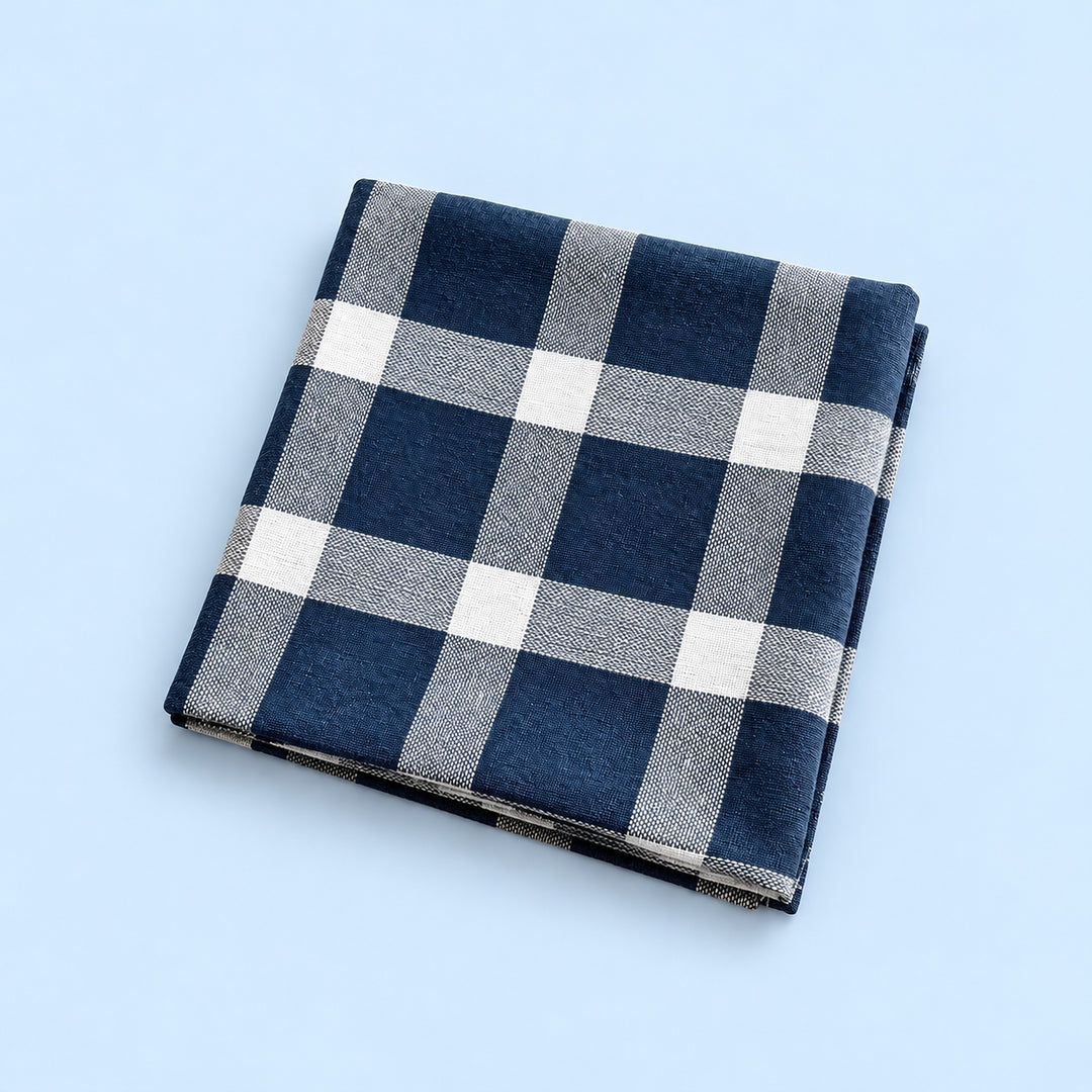 Single blue with white grid cotton towel, folded studio view.
