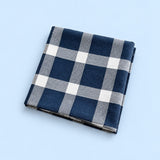 Single blue with white grid cotton towel, folded studio view.