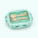 One assembled mint green lunch box with fork and spoon stored beneath clear lid.