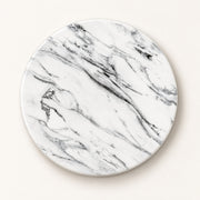 A round coaster with a white marble pattern featuring elegant gray and black veining, shown on a light beige background.