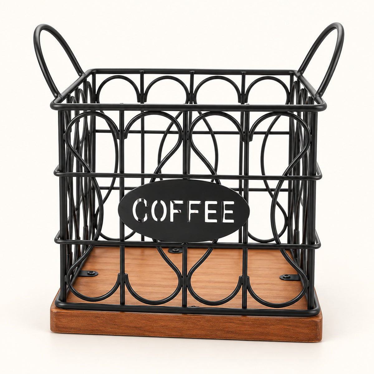 A black metal wire coffee basket with decorative oval wire patterns, a wooden base, and two side handles. A black oval sign on the front reads 'COFFEE' in white letters, set against a plain white background.