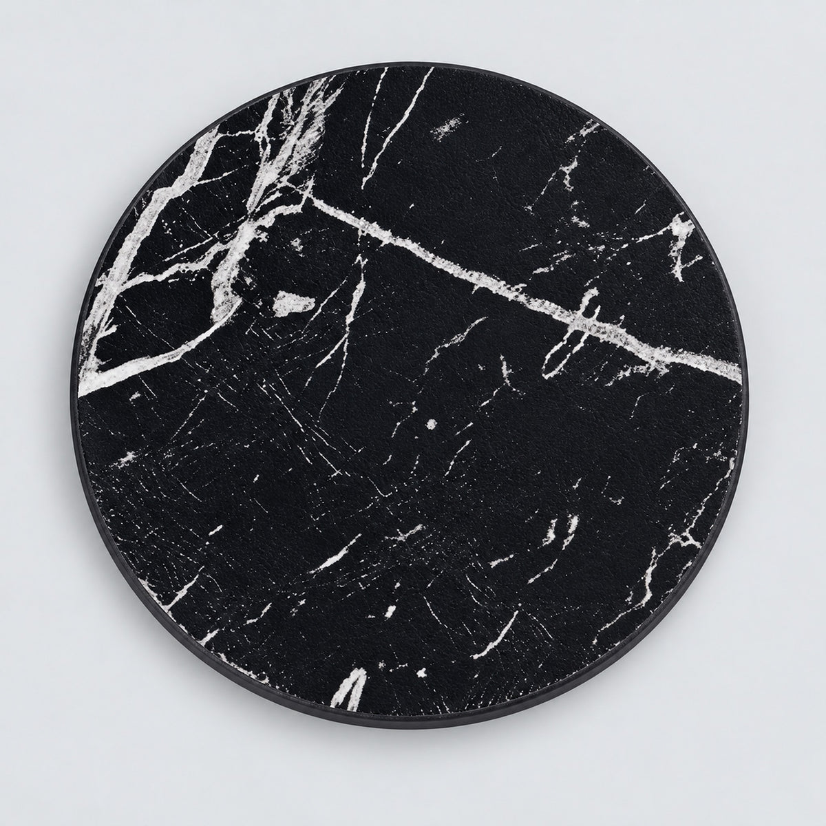 One black artificial-leather coaster, 10 cm.