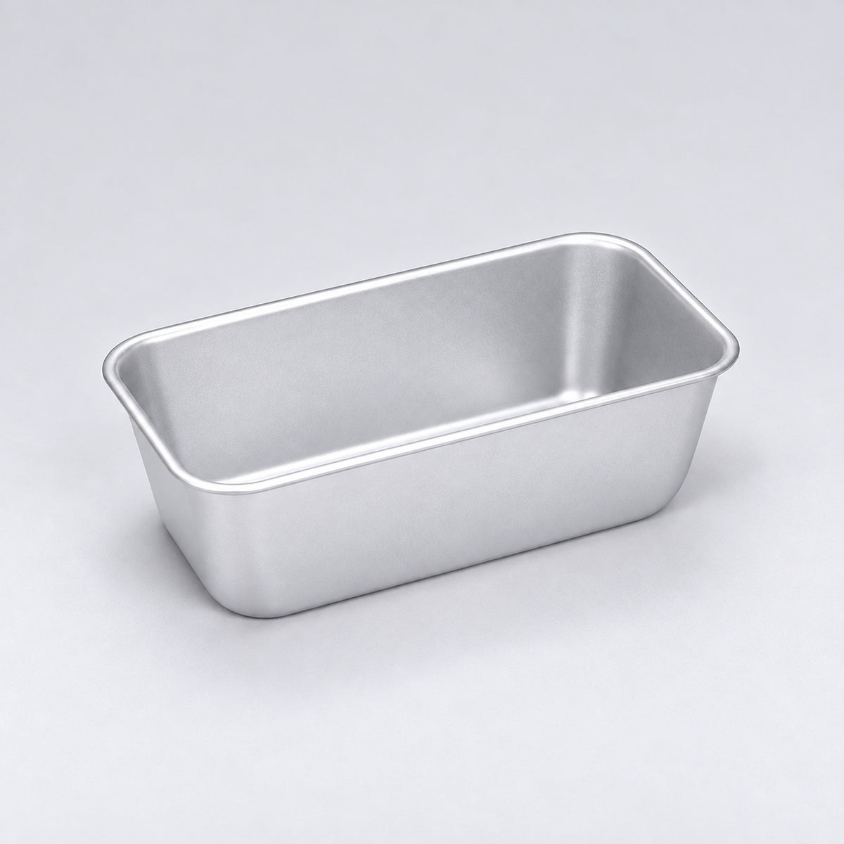 Empty silver aluminum loaf pan, 14.7 x 8.9 x 6.4 cm.