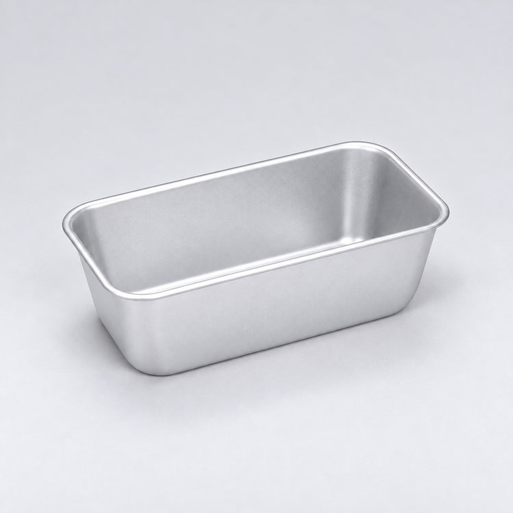 Empty silver aluminum loaf pan, 14.7 x 8.9 x 6.4 cm.