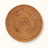 One handwoven round rattan trivet, 16 cm diameter.