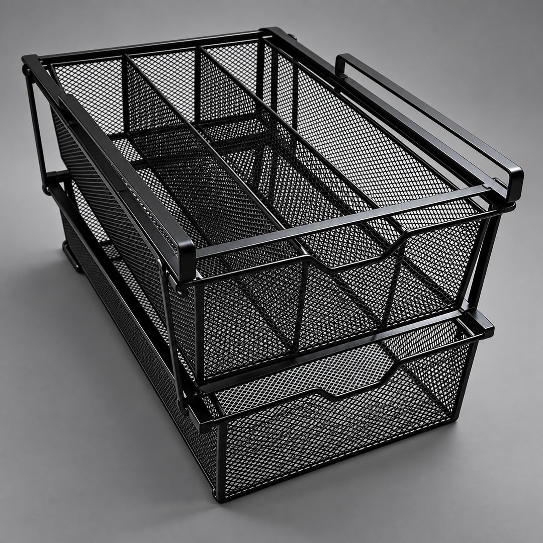 A black metal mesh desk organizer with two stacked pull-out drawers and integrated handles, photographed on a neutral gray studio background.