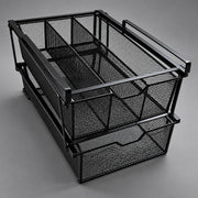 A black metal mesh desk organizer with two stacked pull-out drawers and integrated handles, photographed on a neutral gray studio background.