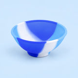Blue, light-blue and white mini silicone bowl, single empty piece in studio.