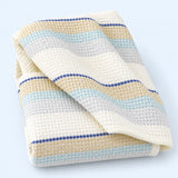 Blue striped waffle cotton towel on pale blue studio background; size selected separately.