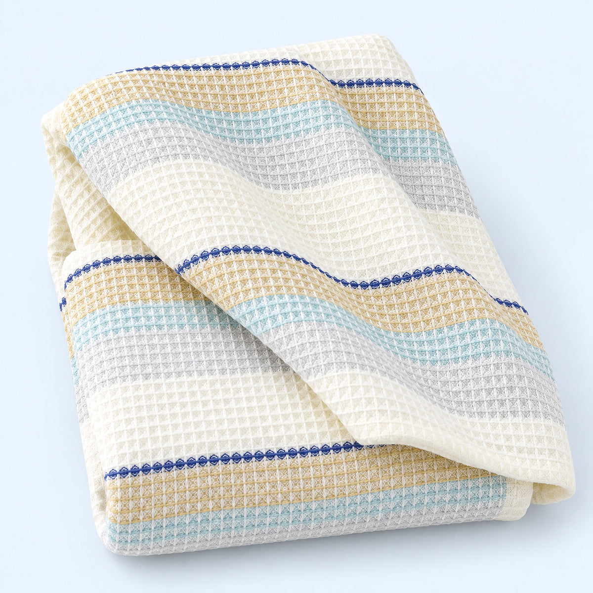 Blue striped waffle cotton towel on pale blue studio background; size selected separately.