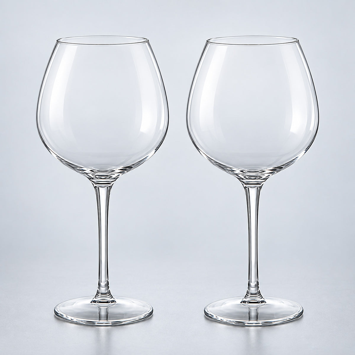 Burgundy set of 2: 2 empty clear stemmed Tritan wine cups on a pale gray studio background.