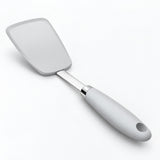 One cool-gray silicone turner spatula on a near-white studio background.
