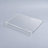 Clear variant: one transparent acrylic cutting board with a counter-edge lip, studio view.