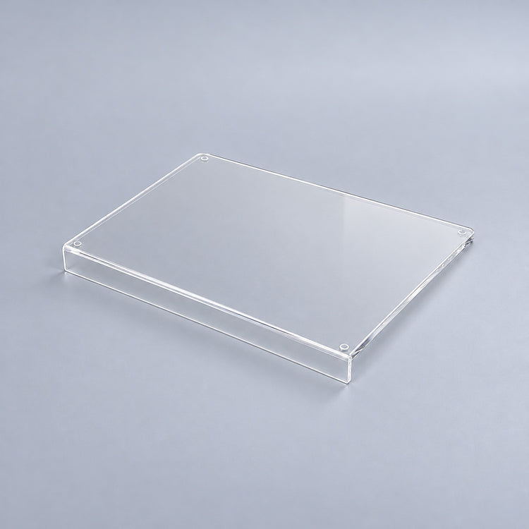 Clear variant: one transparent acrylic cutting board with a counter-edge lip, studio view.