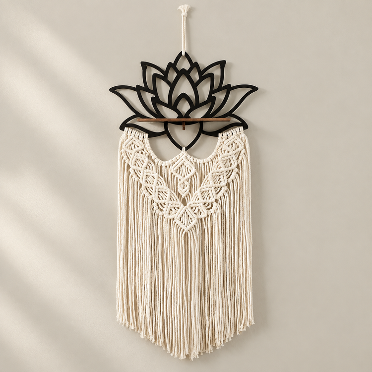 Black lotus macrame wall hanging with black tassels on a cream background