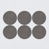 Six dark gray braided round mats.