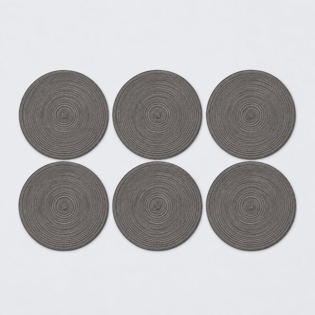 Six dark gray braided round mats.