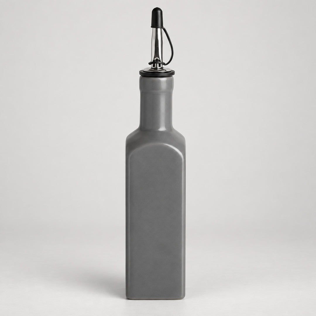 A matte gray rectangular bottle with a pour spout, shown on a light gray studio background.