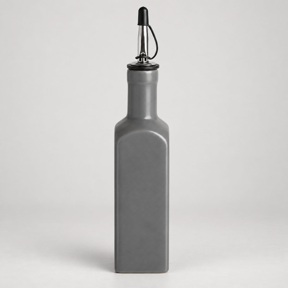 A matte gray rectangular bottle with a pour spout, shown on a light gray studio background.