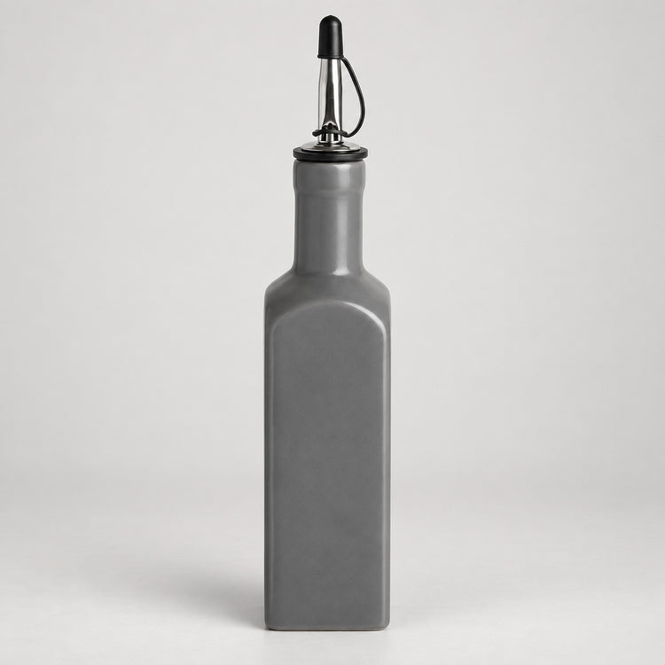A matte gray rectangular bottle with a pour spout, shown on a light gray studio background.