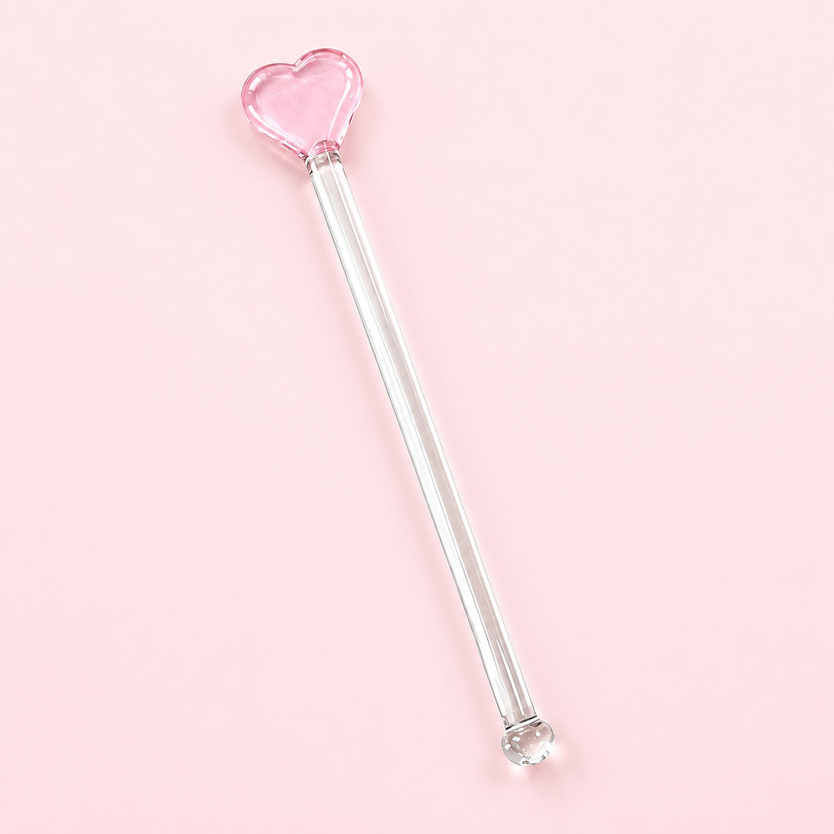 One pink Heart glass stirrer, approximately 12.5 cm long, on pale pink studio background.