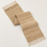 One folded natural jute table runner on a light studio background.