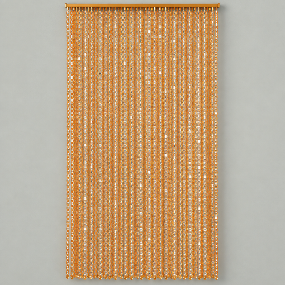A vertical curtain panel made of hanging narrow strands of metallic gold sequins, suspended from a matching gold rod against a solid light gray background.