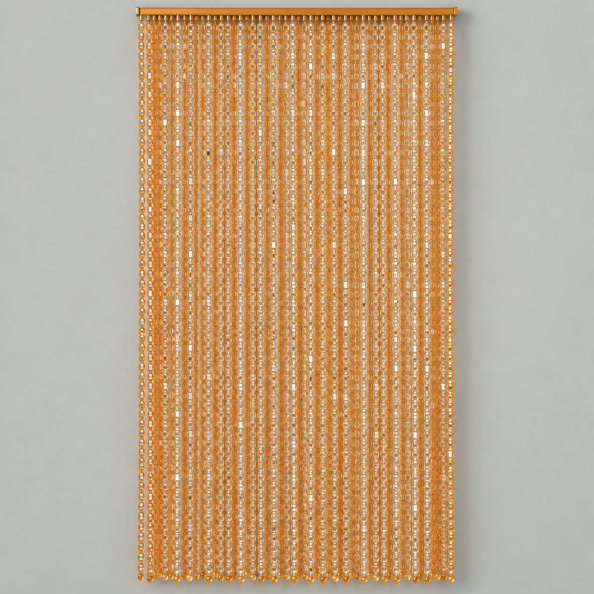 A vertical curtain panel made of hanging narrow strands of metallic gold sequins, suspended from a matching gold rod against a solid light gray background.