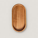 One small, 19 x 10.5 cm oval wood tray on a pale studio background.