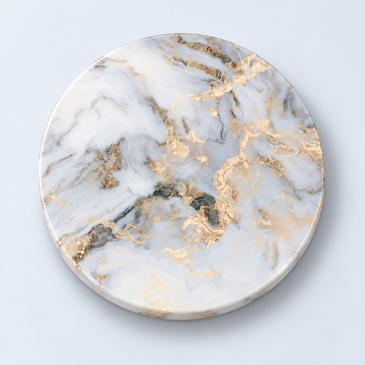A round marble-patterned coaster with white, gray, and gold veining, photographed from directly above on a light blue background.