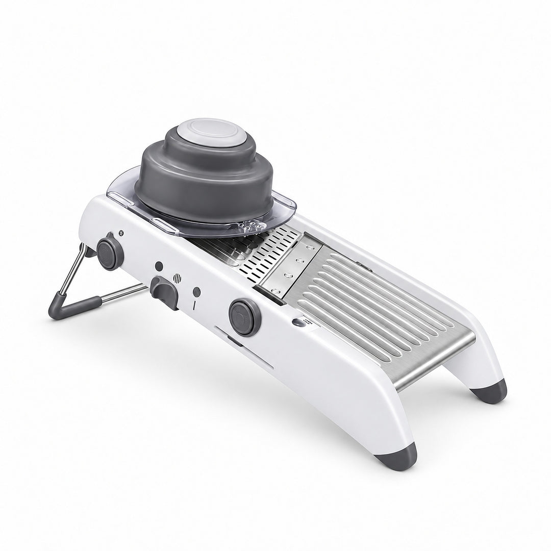 White adjustable mandoline with gray food holder on its steel deck.
