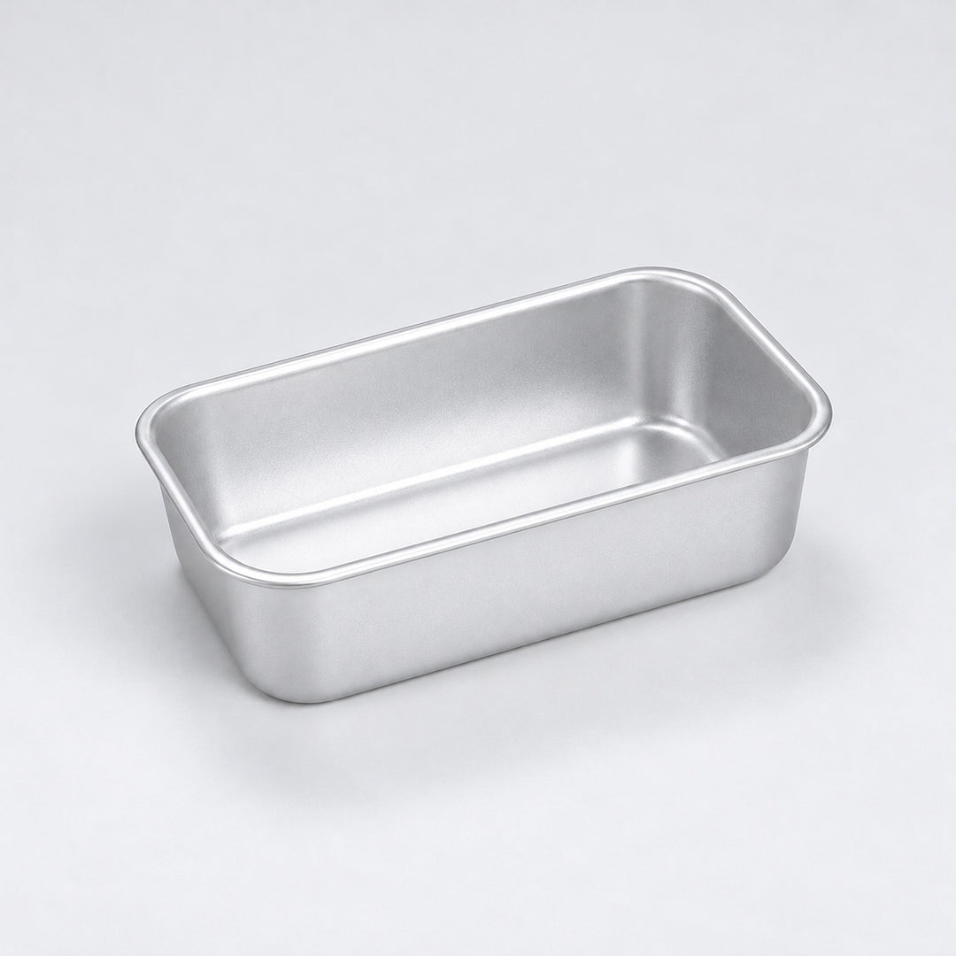 Empty silver aluminum loaf pan, 12 x 7 x 3.8 cm.