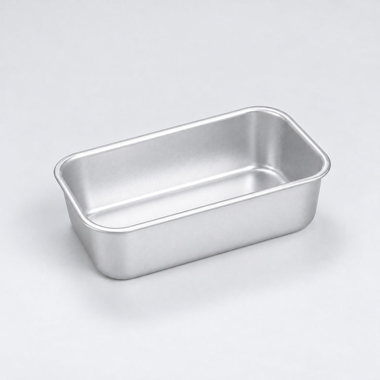 Empty silver aluminum loaf pan, 12 x 7 x 3.8 cm.