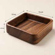 A square wooden tray with rounded corners and a smooth dark brown wood grain finish, shown on a light beige background with dimension lines indicating 15 cm by 15 cm by 4.5 cm measurements.