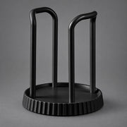 A matte black metal wine bottle rack with a circular base and two upright curved arms, shown on a neutral gray background.