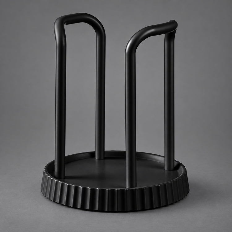 A matte black metal wine bottle rack with a circular base and two upright curved arms, shown on a neutral gray background.