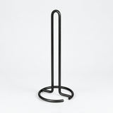 Empty black upright paper towel stand with open wire base.