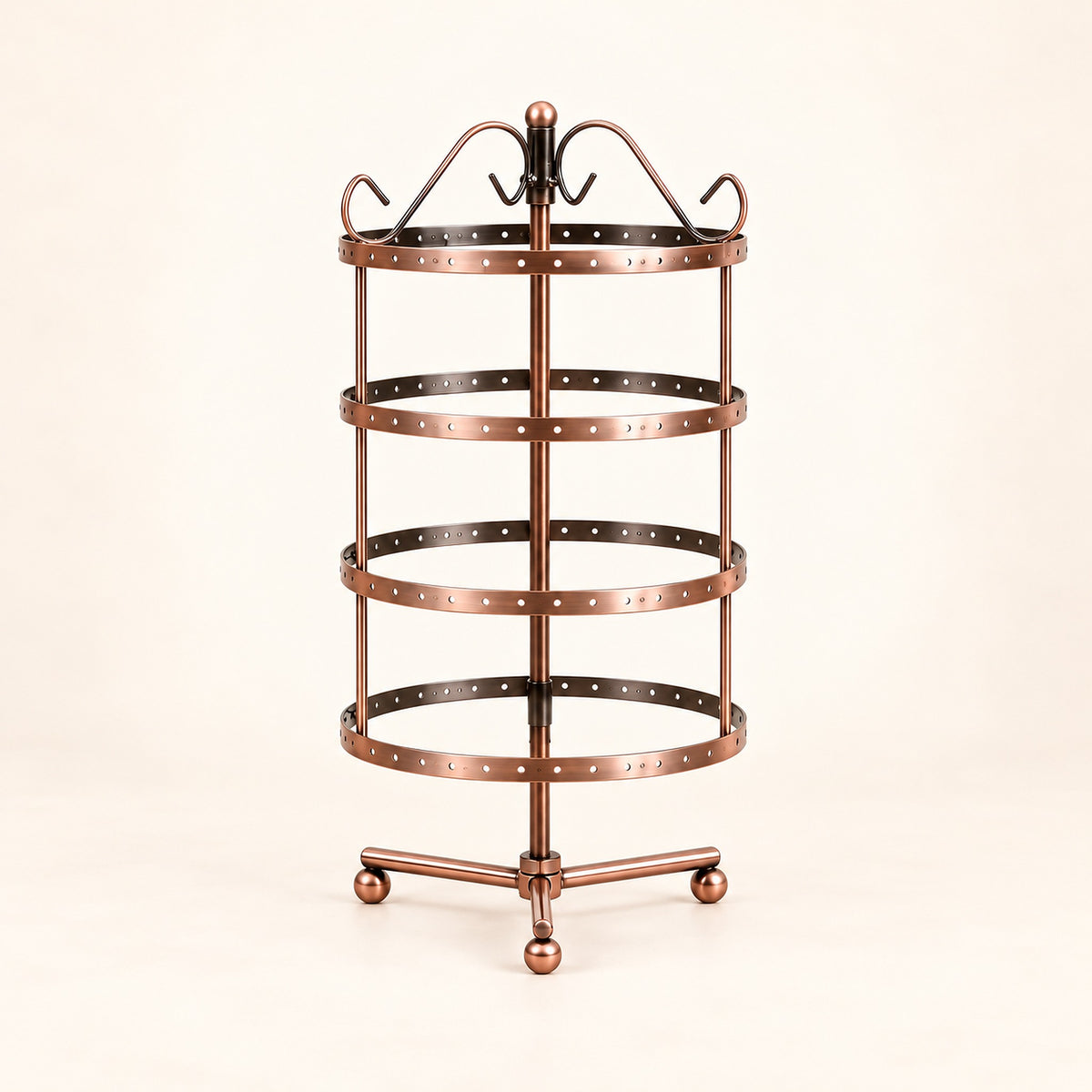 Empty bronze four-tier jewelry stand with bronze three-foot tripod with ball-ended feet.