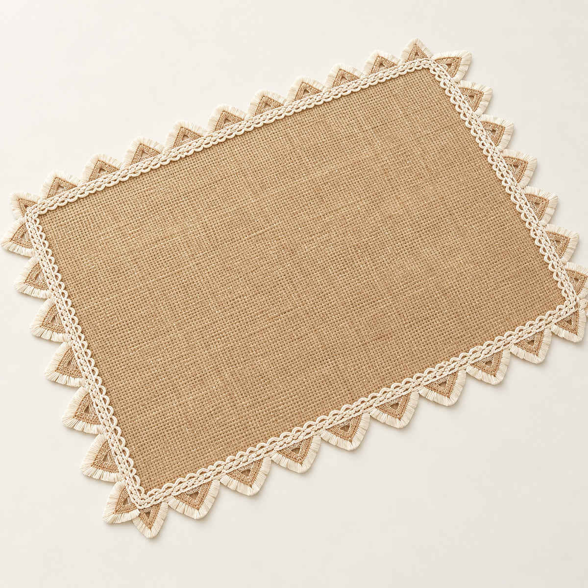 One tan placemat with cream triangle trim, 30 x 45 cm.