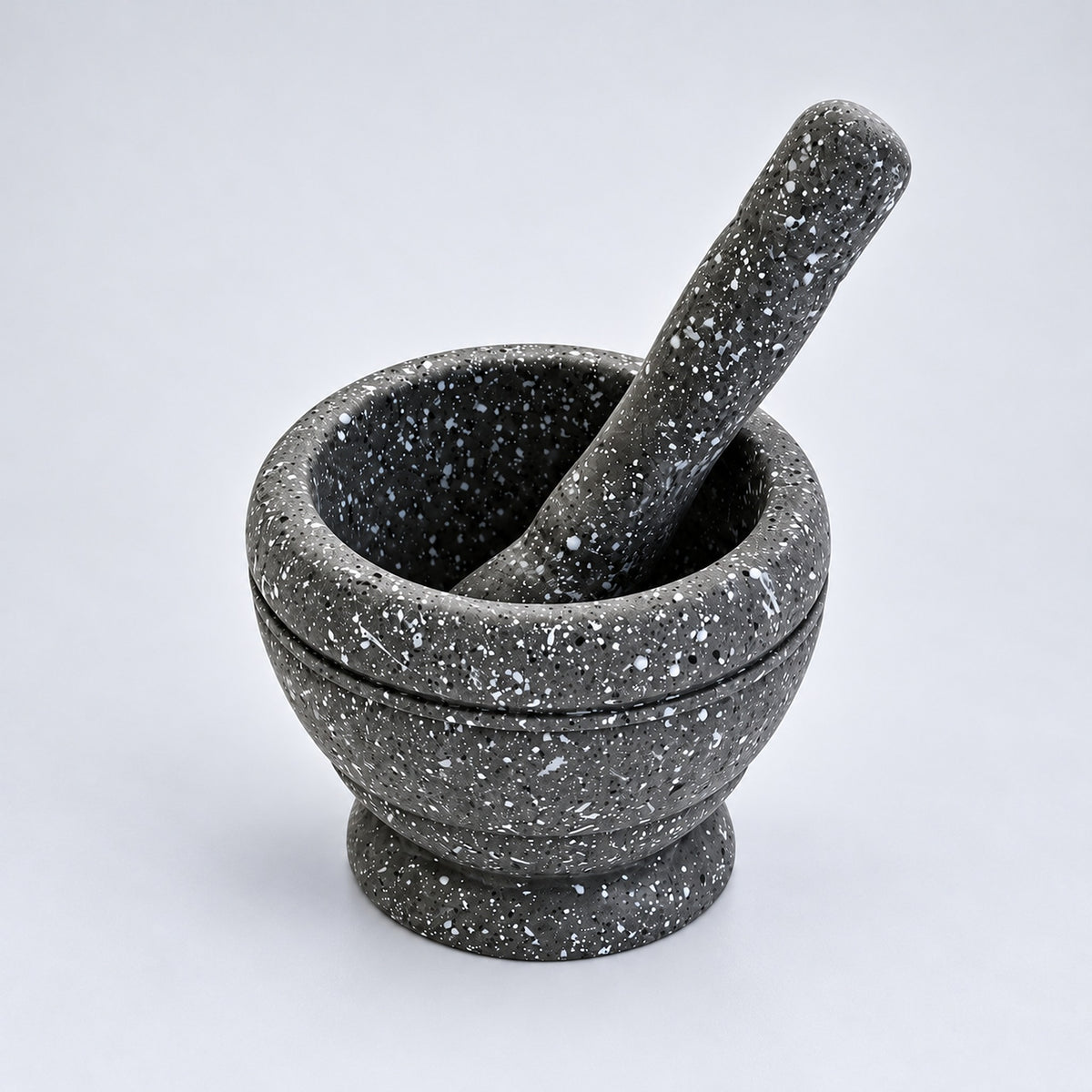 Gray variant: one gray speckled mortar and matching pestle on a lighter gray background.