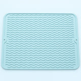 Light blue wavy-ridge silicone mat with two hanging holes.